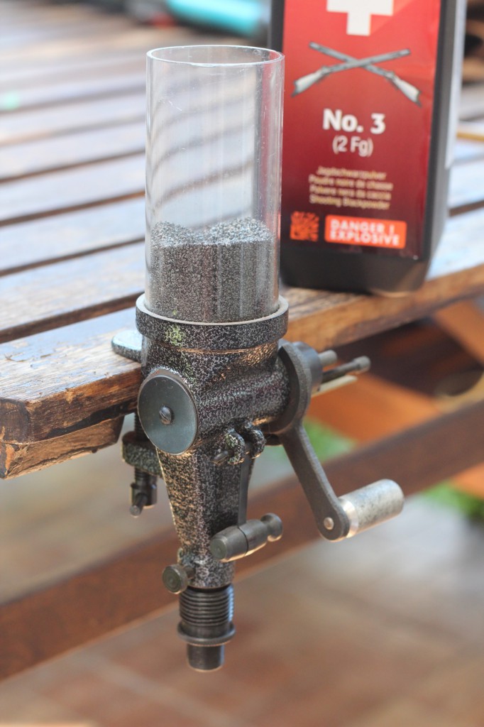 A bench mounted volumetric measure: quick and easy way, but the volume and weight of charge is depending on how much powder you have in the reservoir. Also note that many makers do not recommend using their measure with blackpowder.